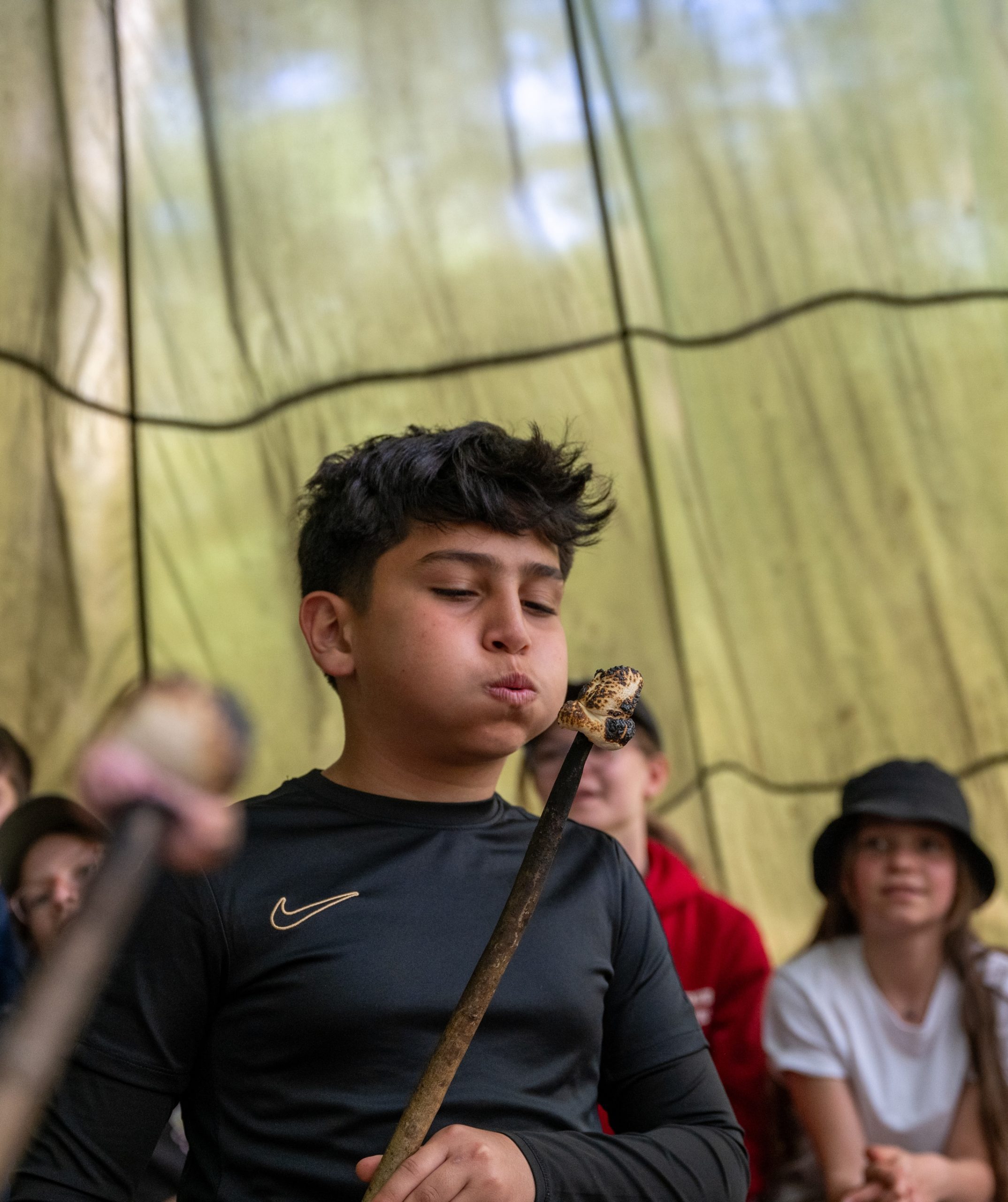 boy on bushcraft trip with marshmallow
