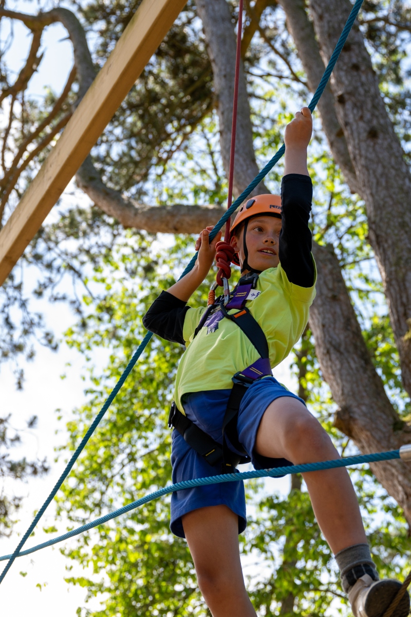 boy on high ropes course on primary school residential