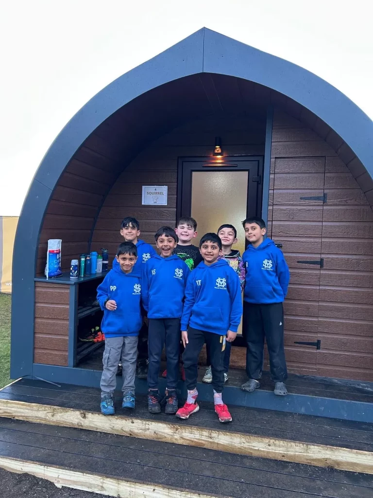 school boys outside a rootd pod on a school residential trip